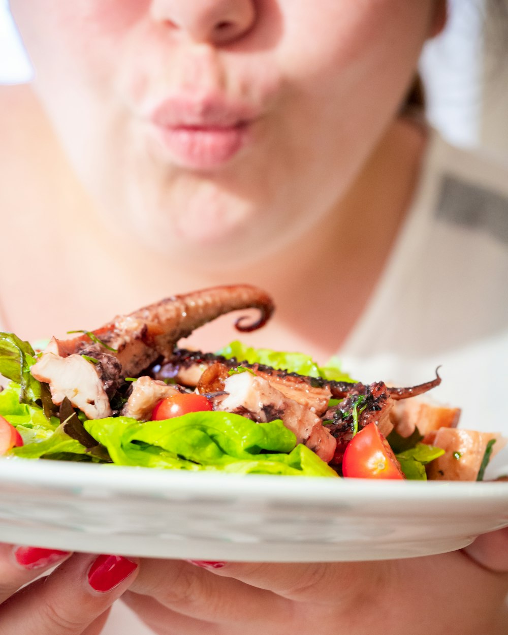 a woman is holding a plate of food