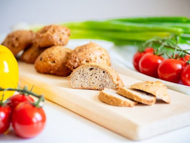 a cutting board topped with sliced Keto bread and tomatoes