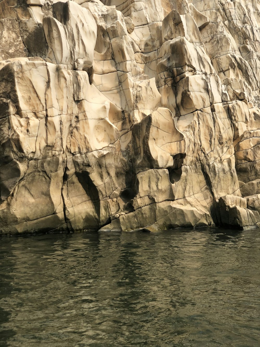 a large rock formation next to a body of water