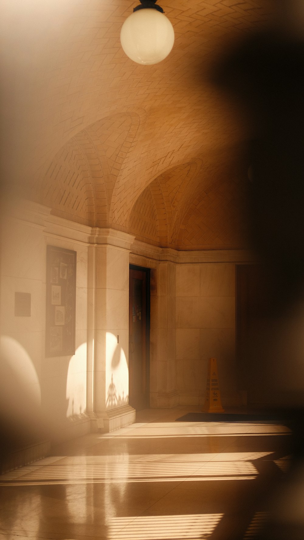 a large room with a ceiling fan and a light fixture