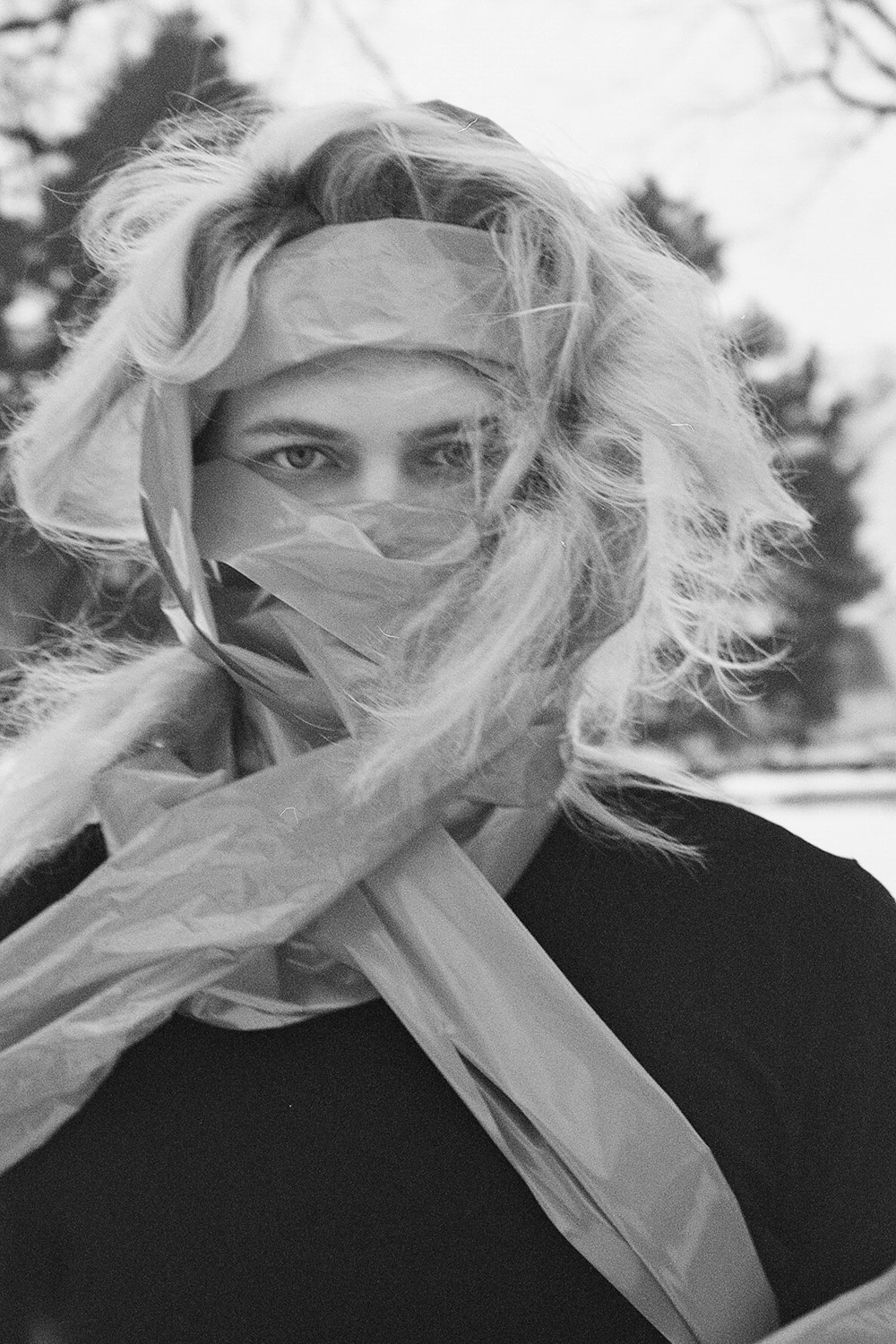 a black and white photo of a woman wearing a scarf