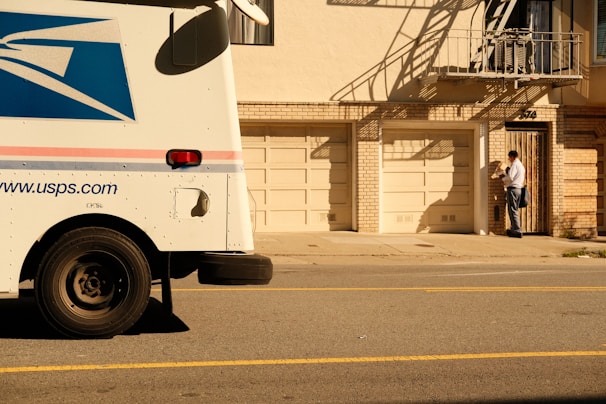 a mail truck parked on the side of the road