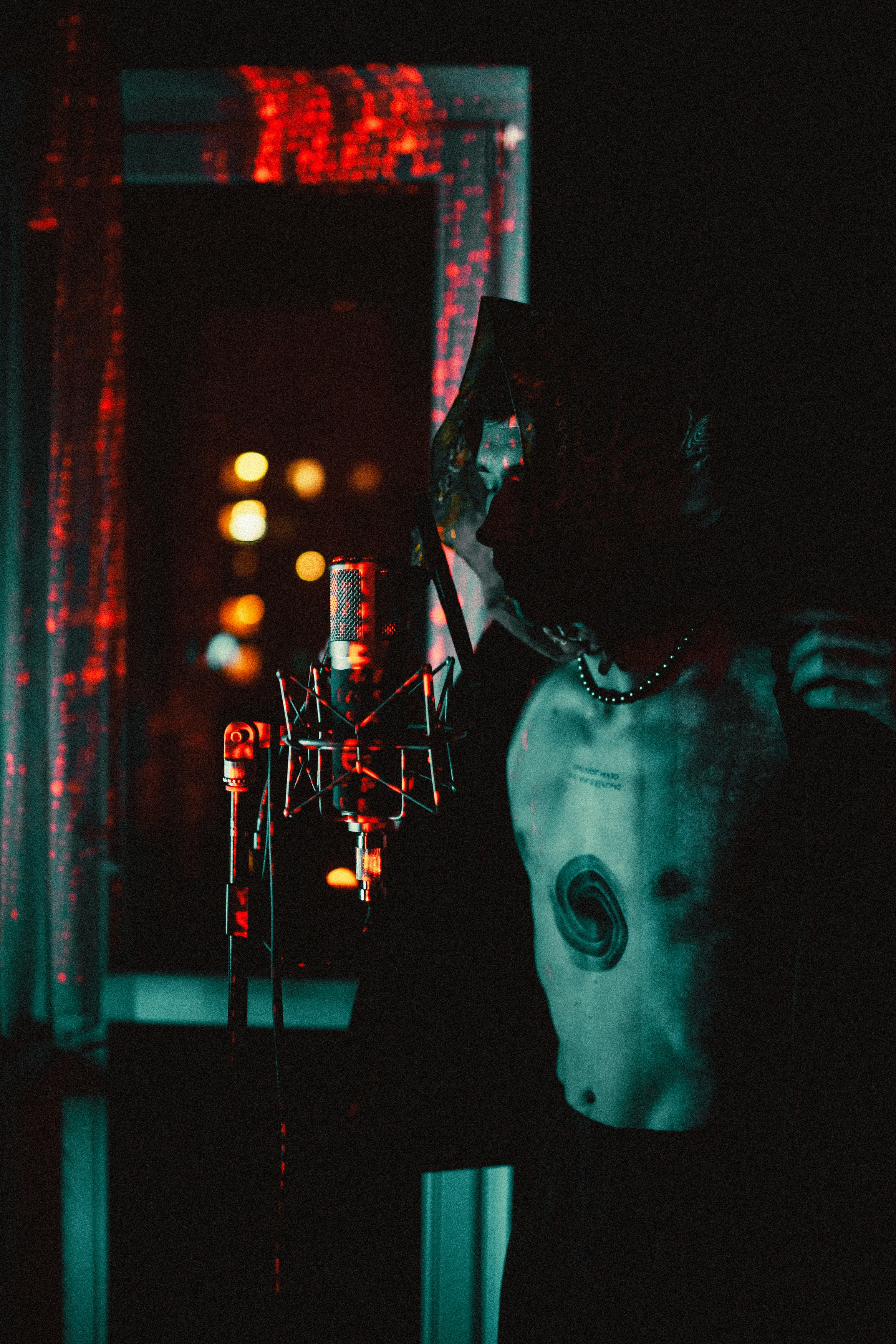 a man standing in a dark room next to a window
