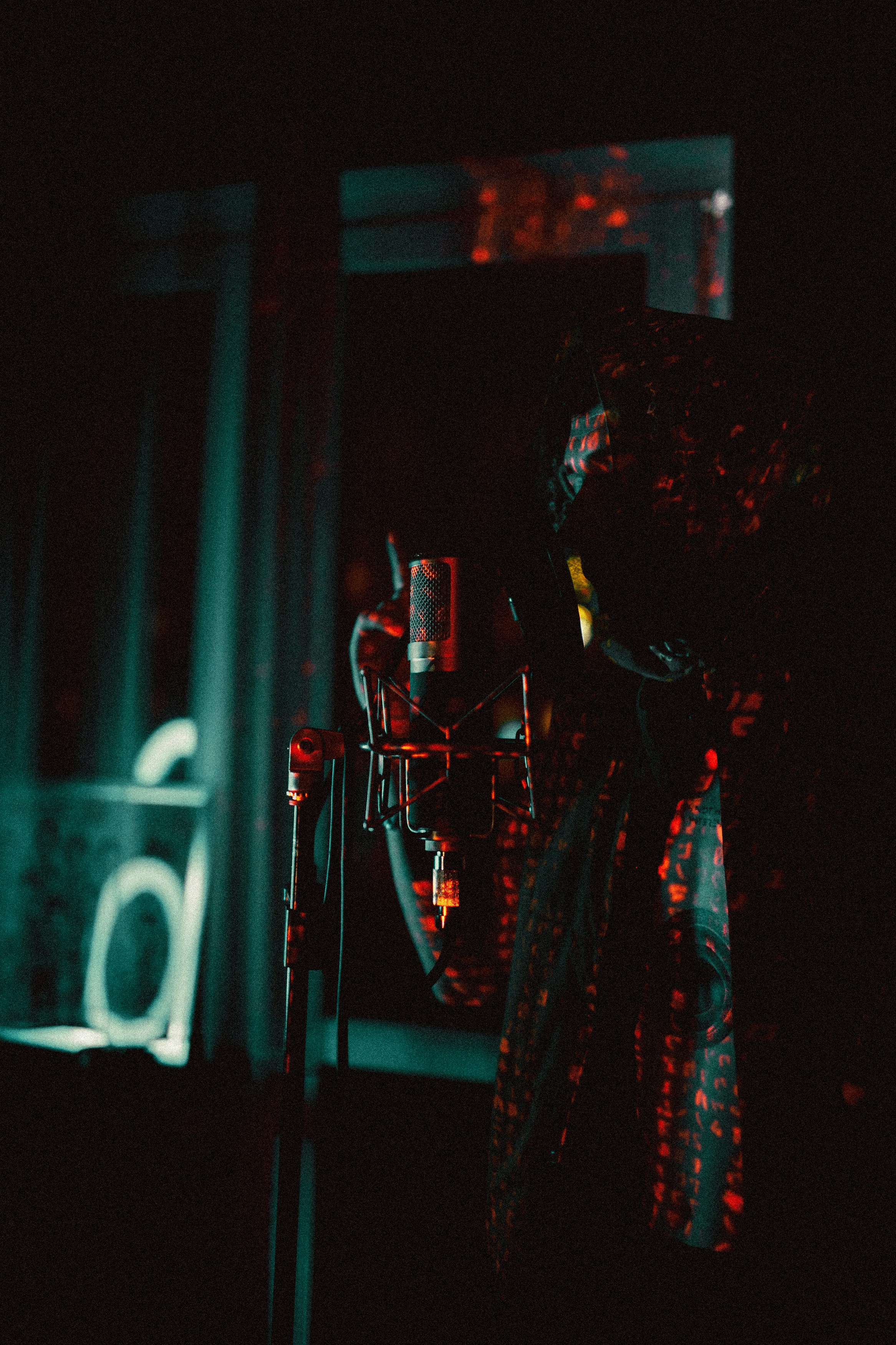 a person with a microphone in a dark room