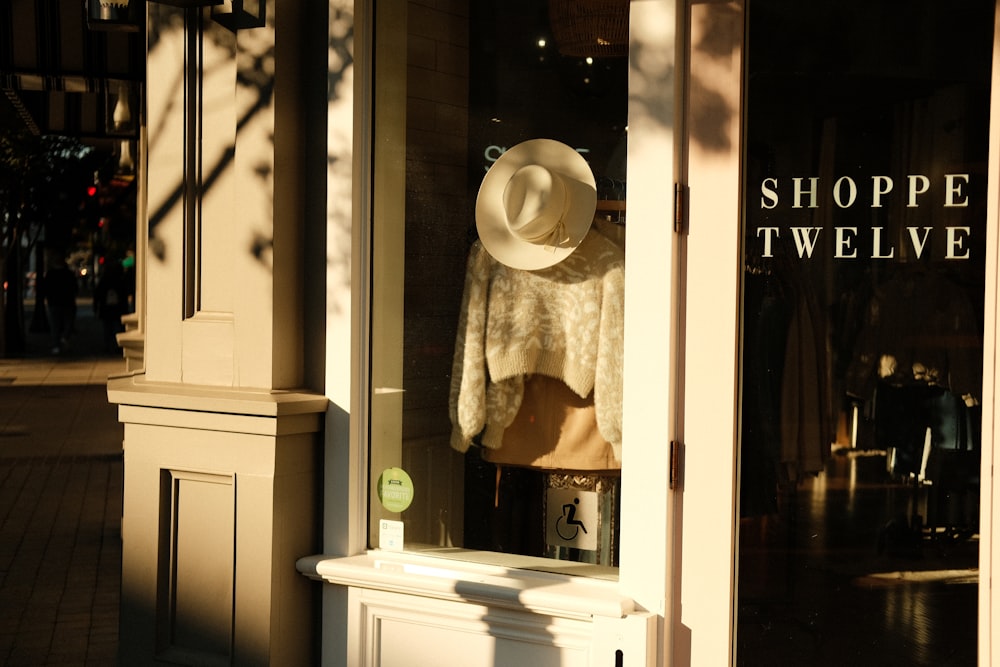 a storefront with a hat on top of it