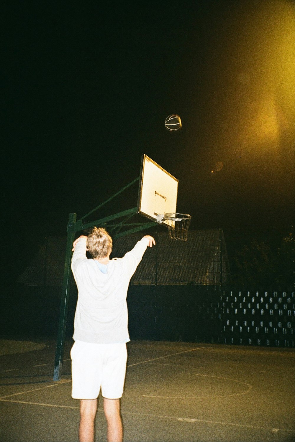 a young man is playing basketball on a court