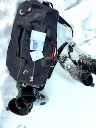 Close-up of a stylish Nestora storage bag filled with winter clothes.
