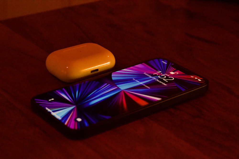 a cell phone sitting on top of a wooden table