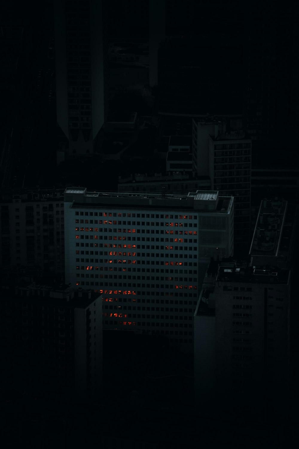 a building with a red light on it in the dark