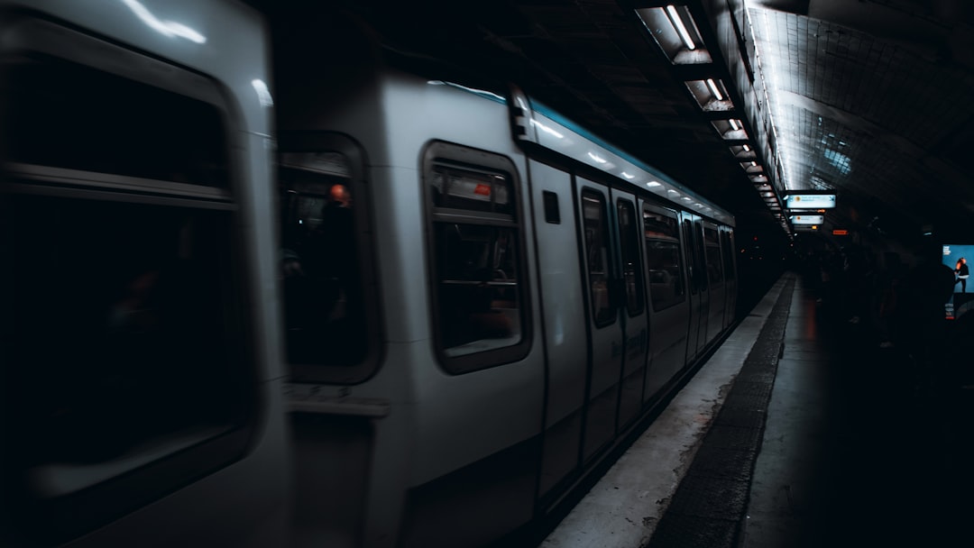 a subway train pulling into a train station,