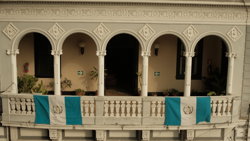 a balcony with blue and white curtains on it