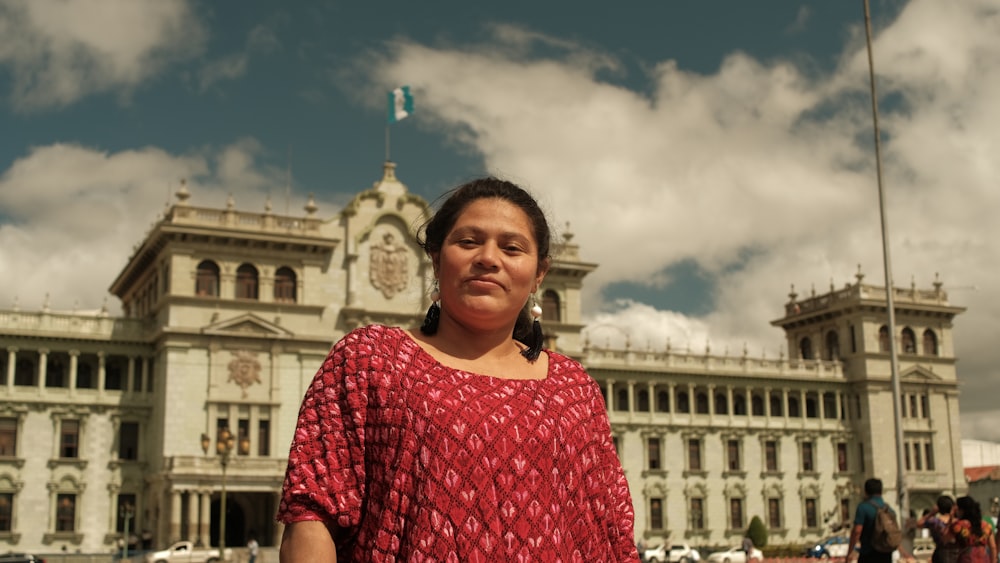 a woman standing in front of a large building