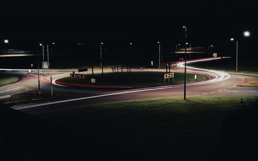 a night time picture of a street intersection