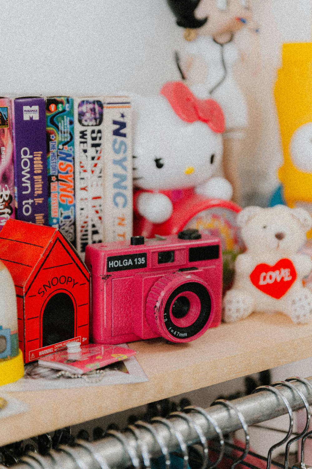 a wooden shelf topped with lots of toys and books