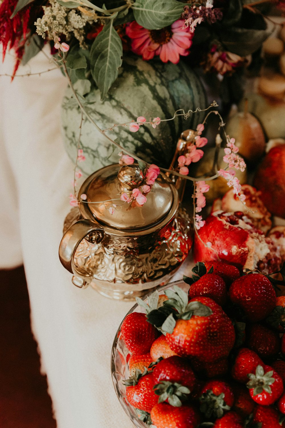 a table topped with a bowl of strawberries