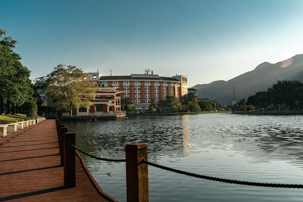 a large building sitting on top of a lake next to a dock