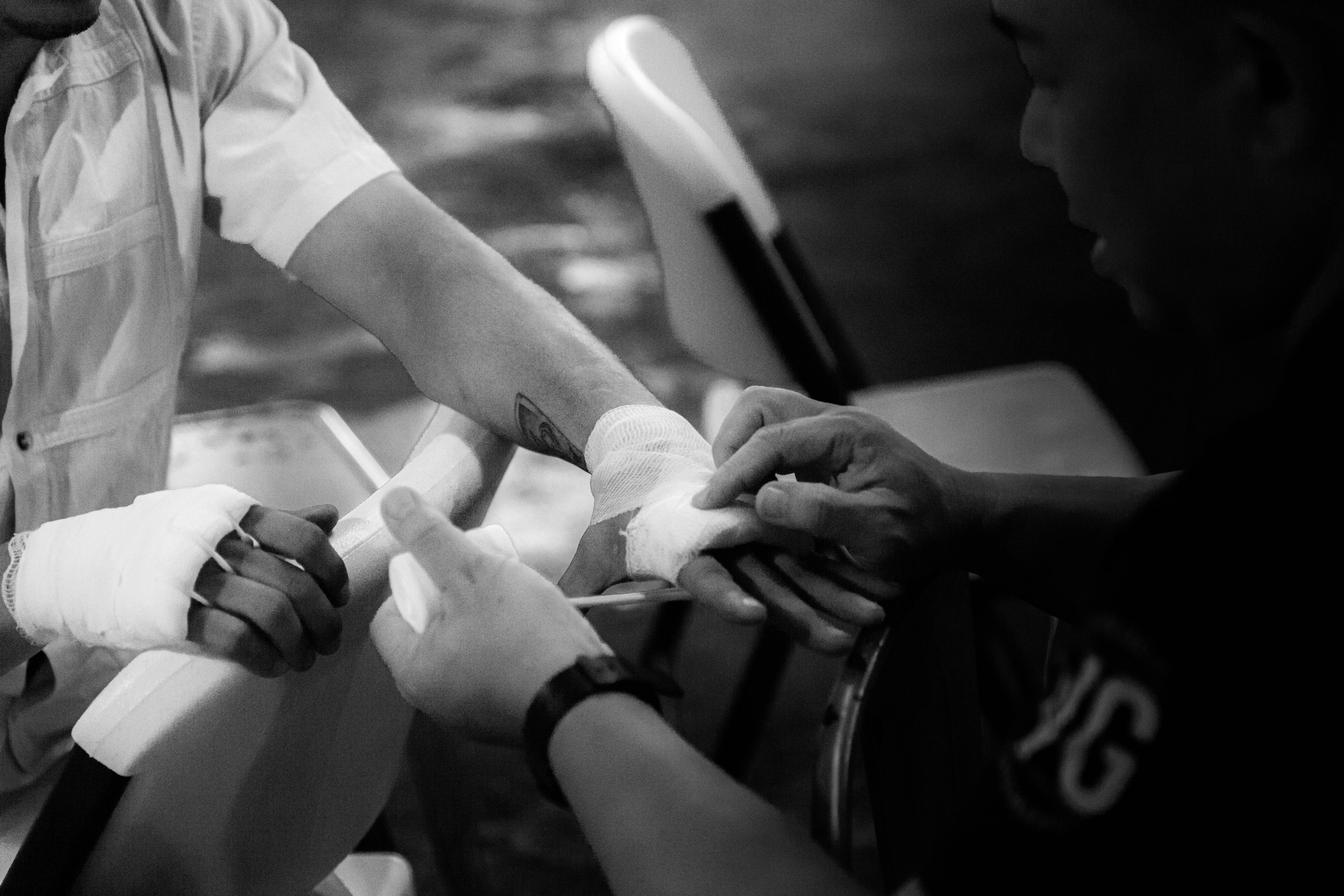 a black and white photo of a group of people holding hands