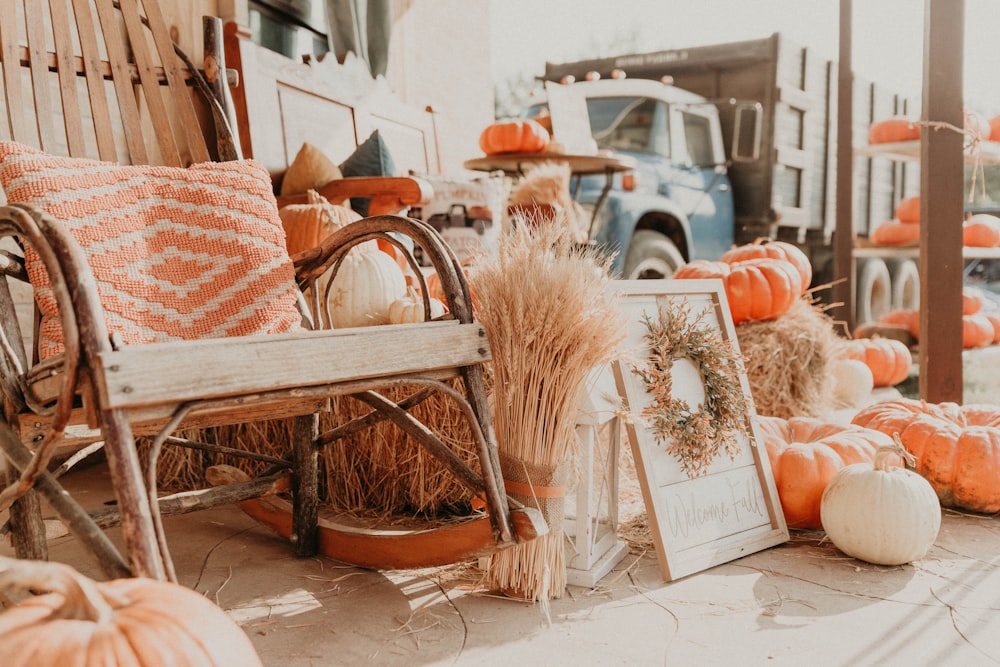 a wooden bench sitting next to a pile of pumpkins