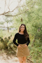 A young woman posing naturally outdoors for a personal portrait photo shoot
