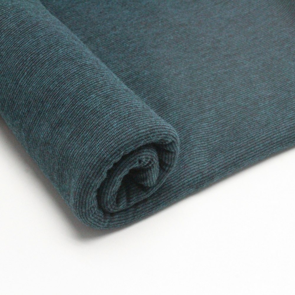 a close up of a blue fabric on a white surface