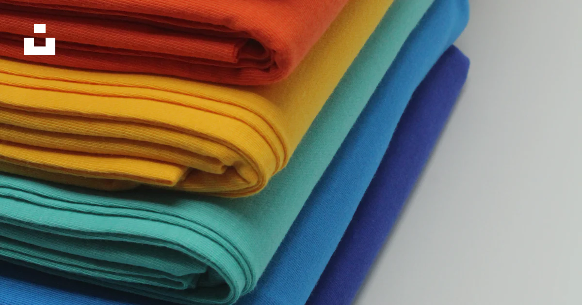 Set Color Cloth A stack of bright colored cloths on a white surface photo – Free Tc ...