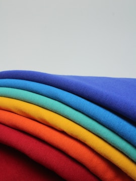 Rongzhiyue: a stack of different colored t - shirts sitting on top of each other