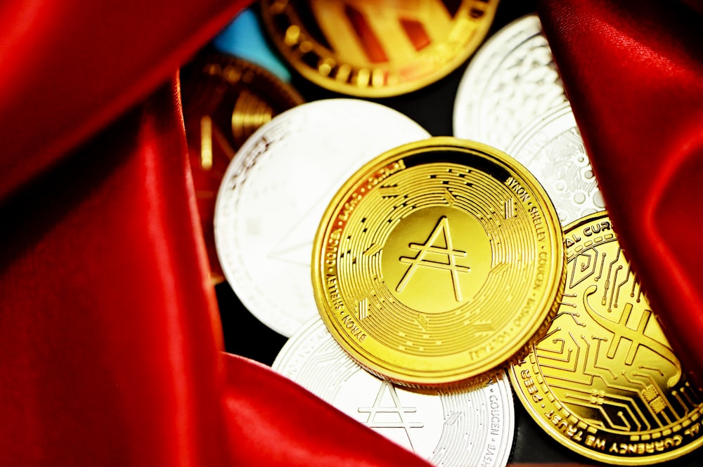 a close up of a bunch of coins under a red cloth