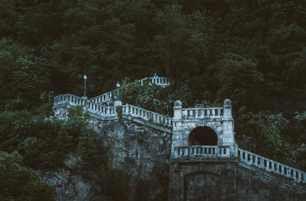 a stone wall with a tunnel in the middle of it