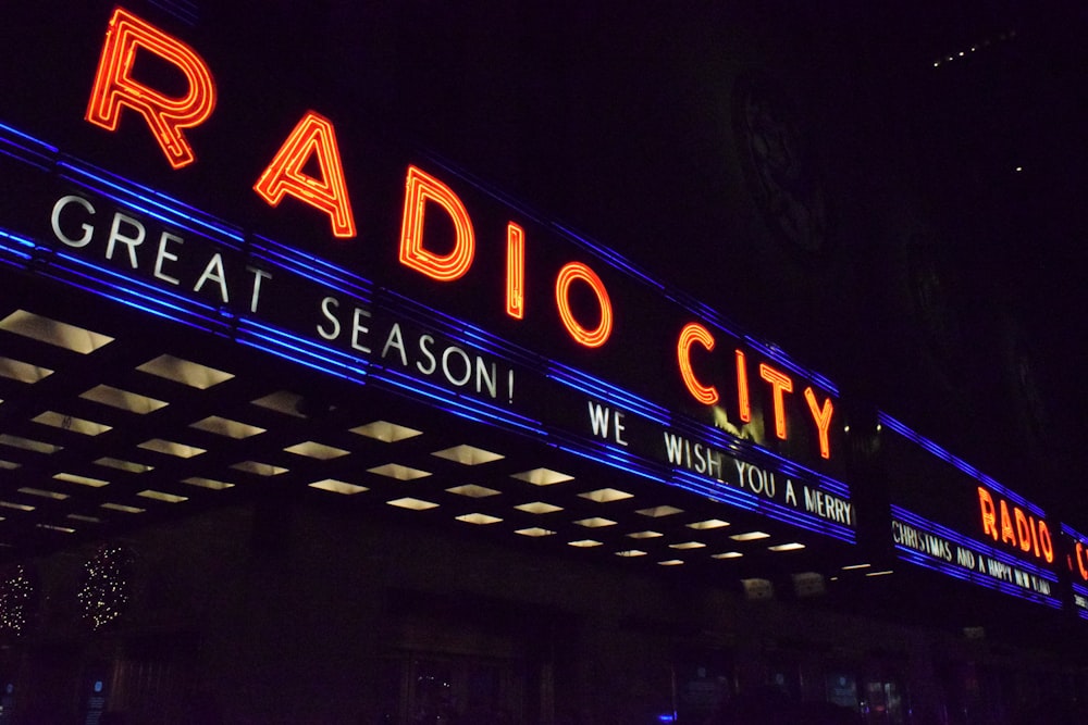 a radio city sign lit up at night