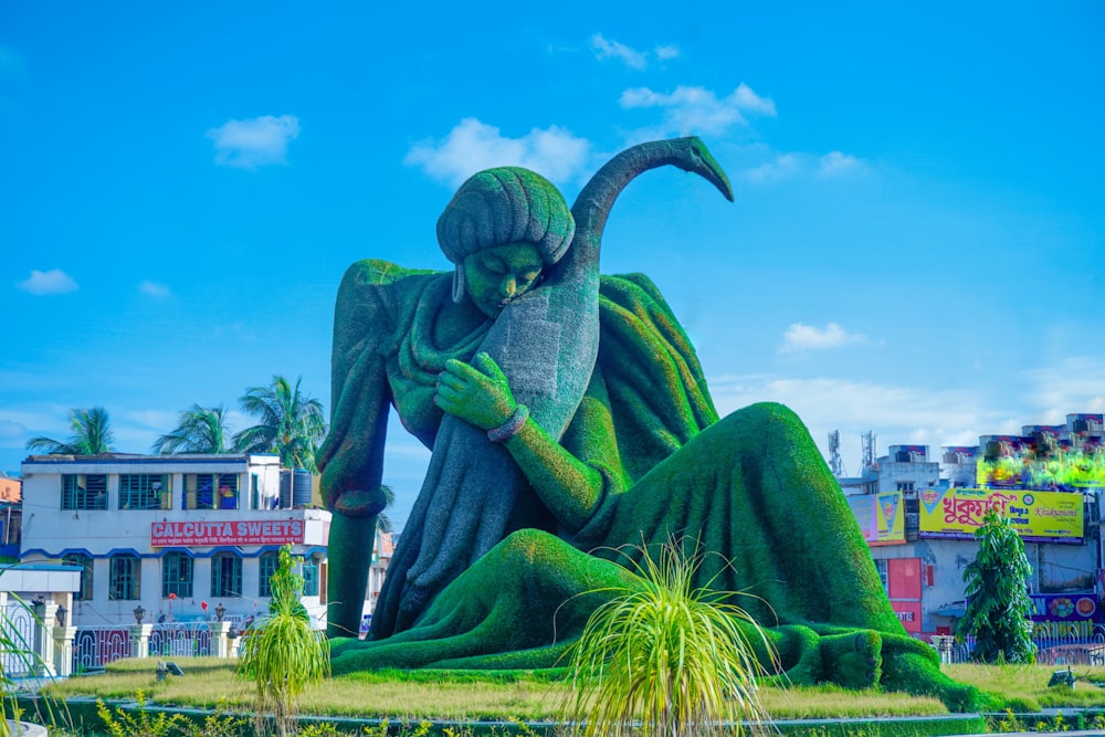 a statue of a woman with a bird in her hand