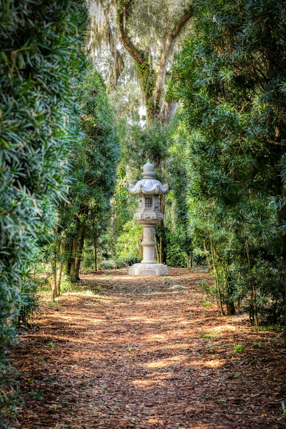 a stone lantern in the middle of a forest