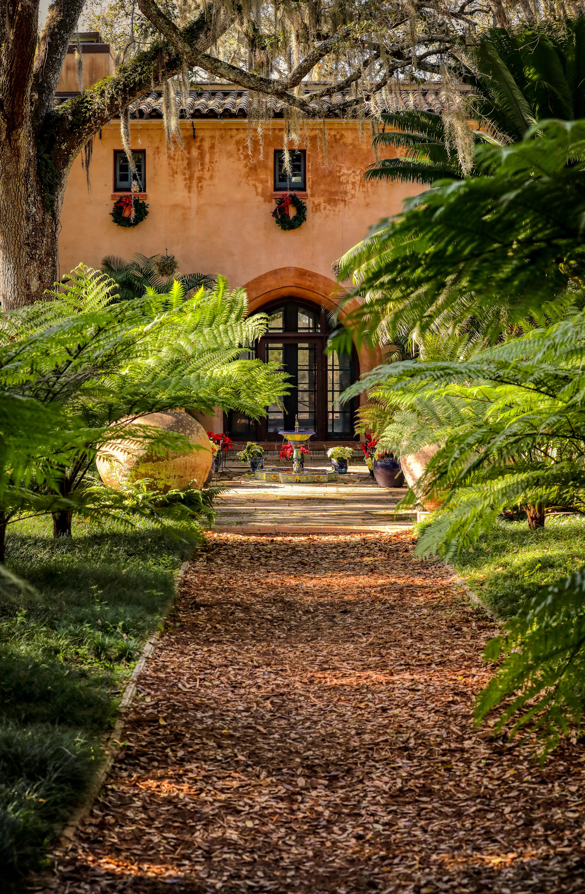 a pathway leading to a building with a clock on it