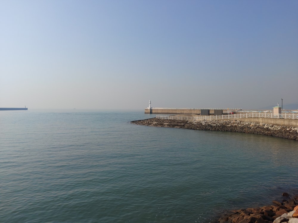 a large body of water next to a pier