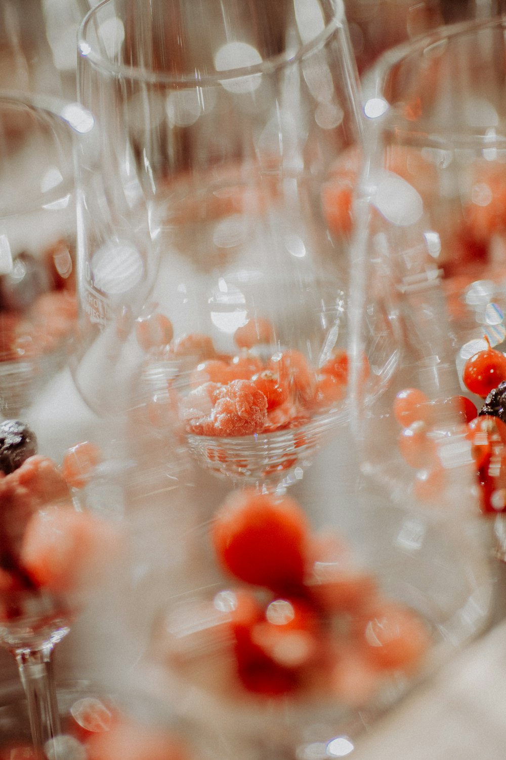 a table topped with lots of wine glasses filled with fruit