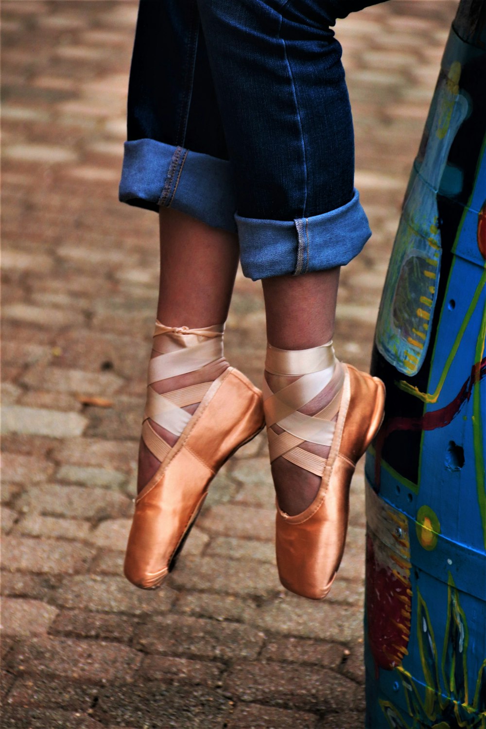 a person wearing a pair of shoes standing next to a parking meter