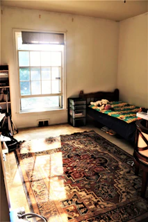 Bright and cozy bedroom with a single bed and personal storage in a shared home