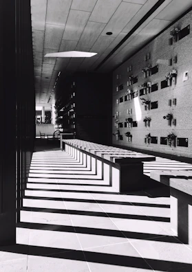 Wide view of a peaceful memorial wall bathed in soft, spiritual light rays.