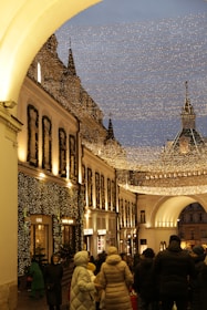 Families and friends enjoying street food and warm drinks under twinkling lights.