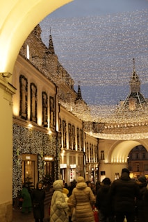 Families and friends enjoying street food and warm drinks under twinkling lights.
