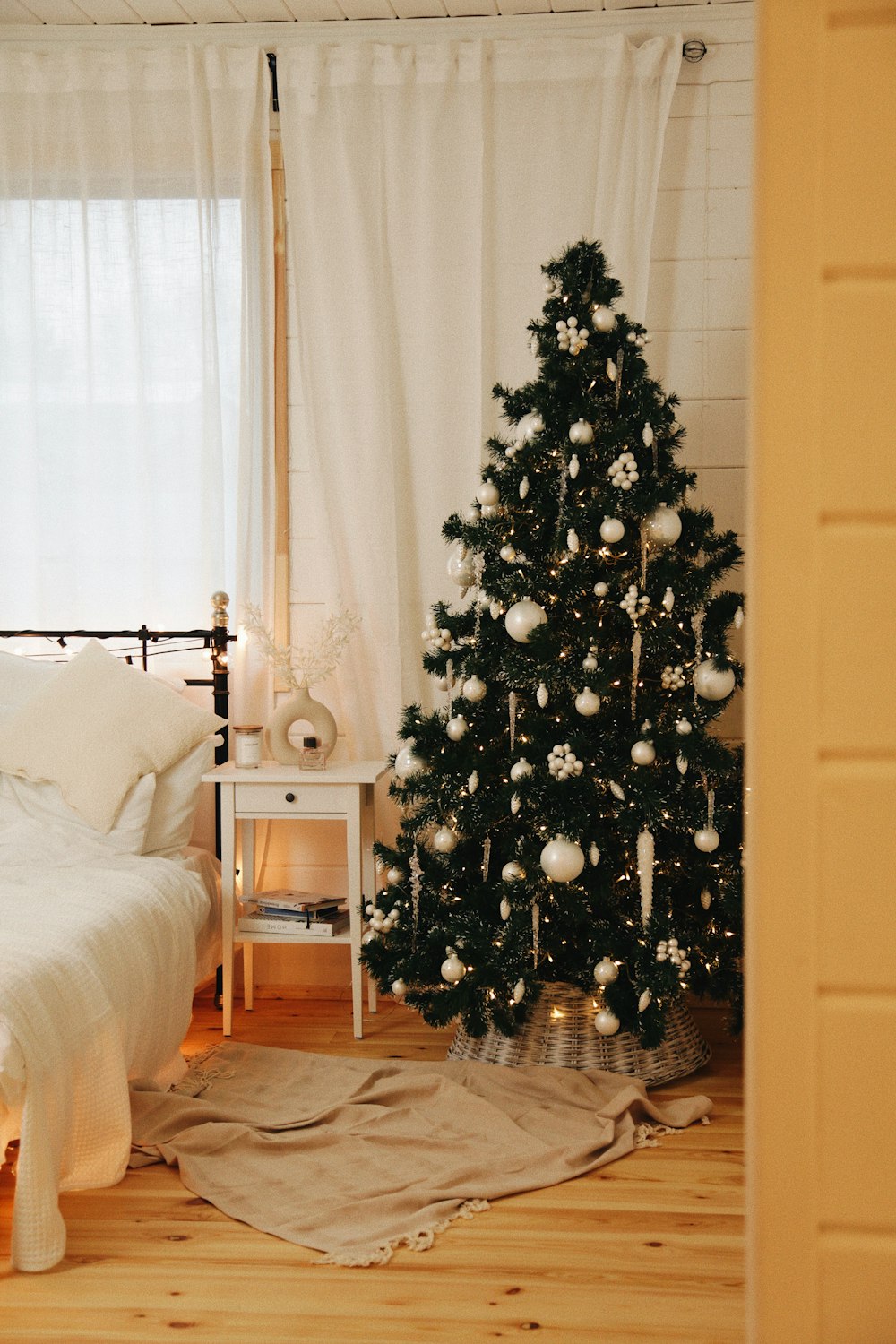 a bedroom with a christmas tree in the corner