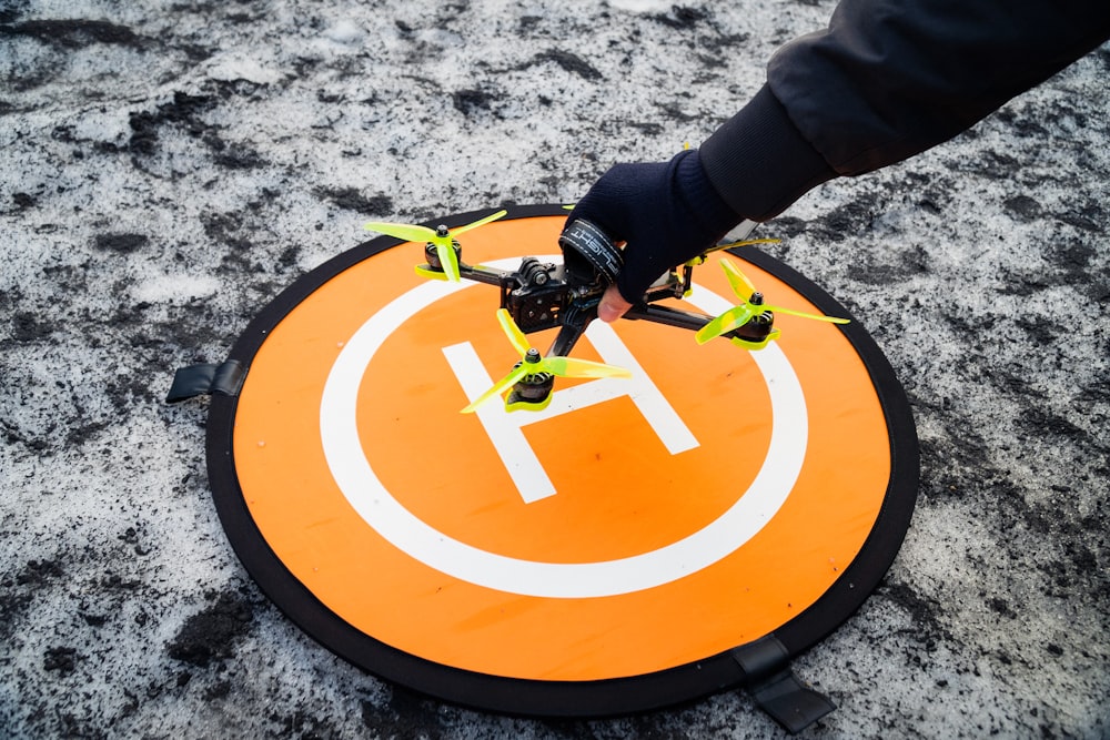 a person holding a remote control device on top of a sign