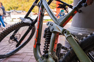 Close-up of a rugged mountain bike suspension absorbing a big hit on a downhill track.