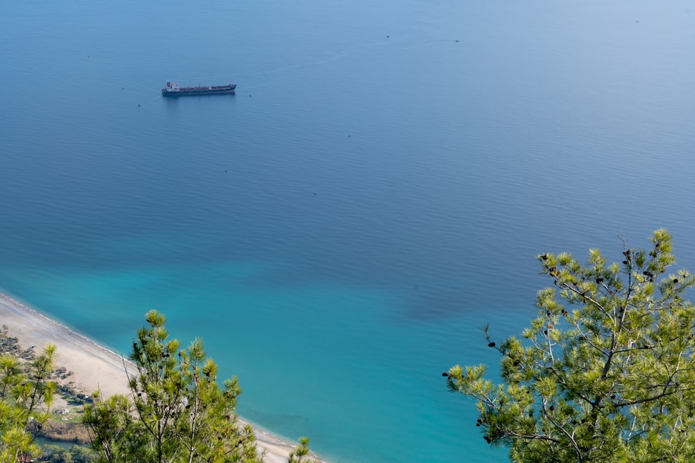 a boat floating in the middle of a body of water