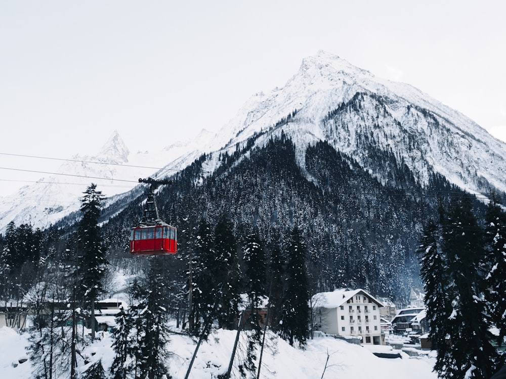 a ski lift going up the side of a snow covered mountain