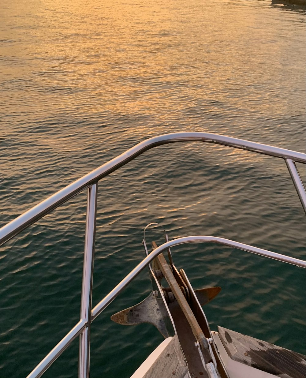 a boat traveling on a body of water at sunset