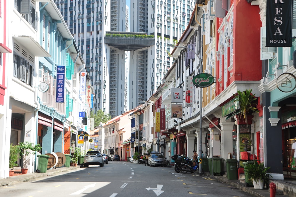 a city street lined with tall buildings and parked cars