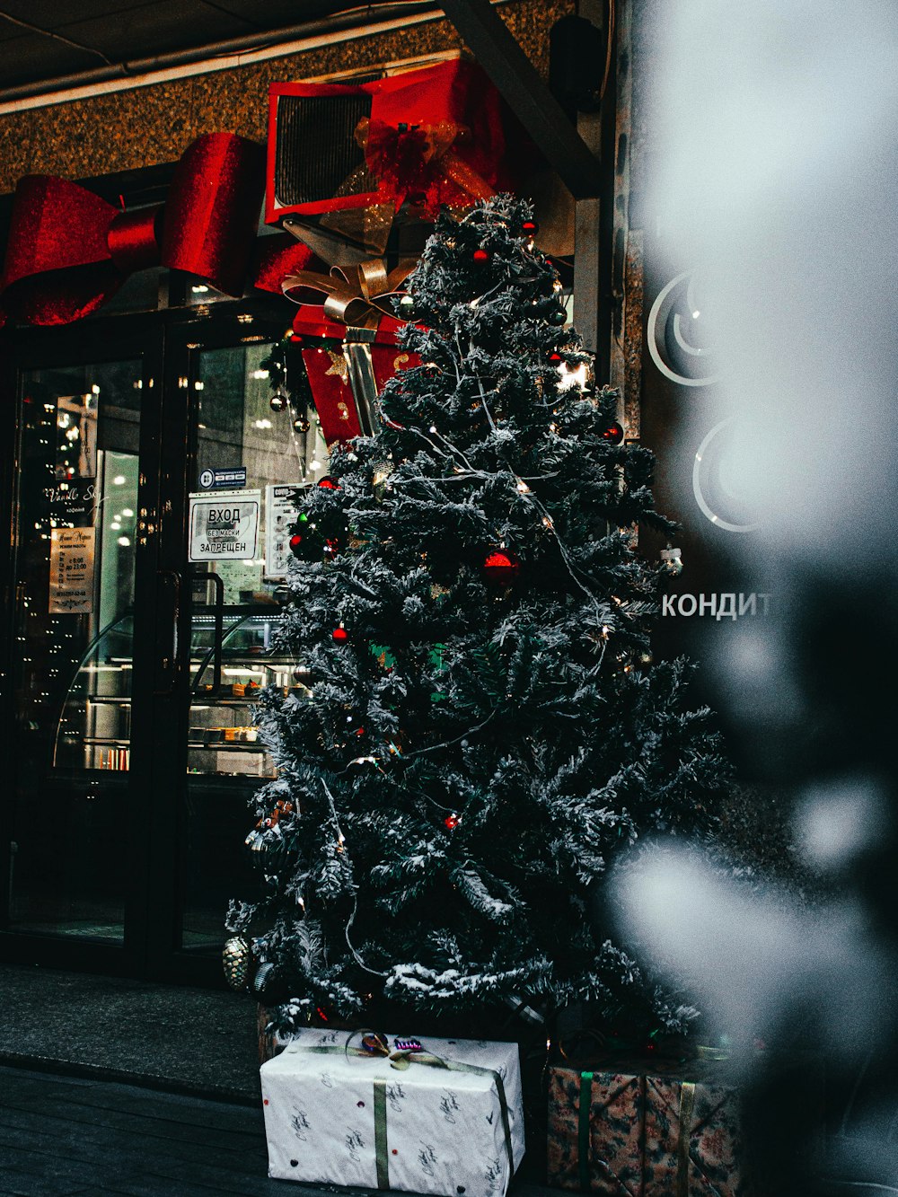 a christmas tree outside of a store front