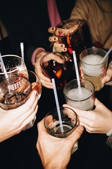 a group of people holding glasses with drinks in them
