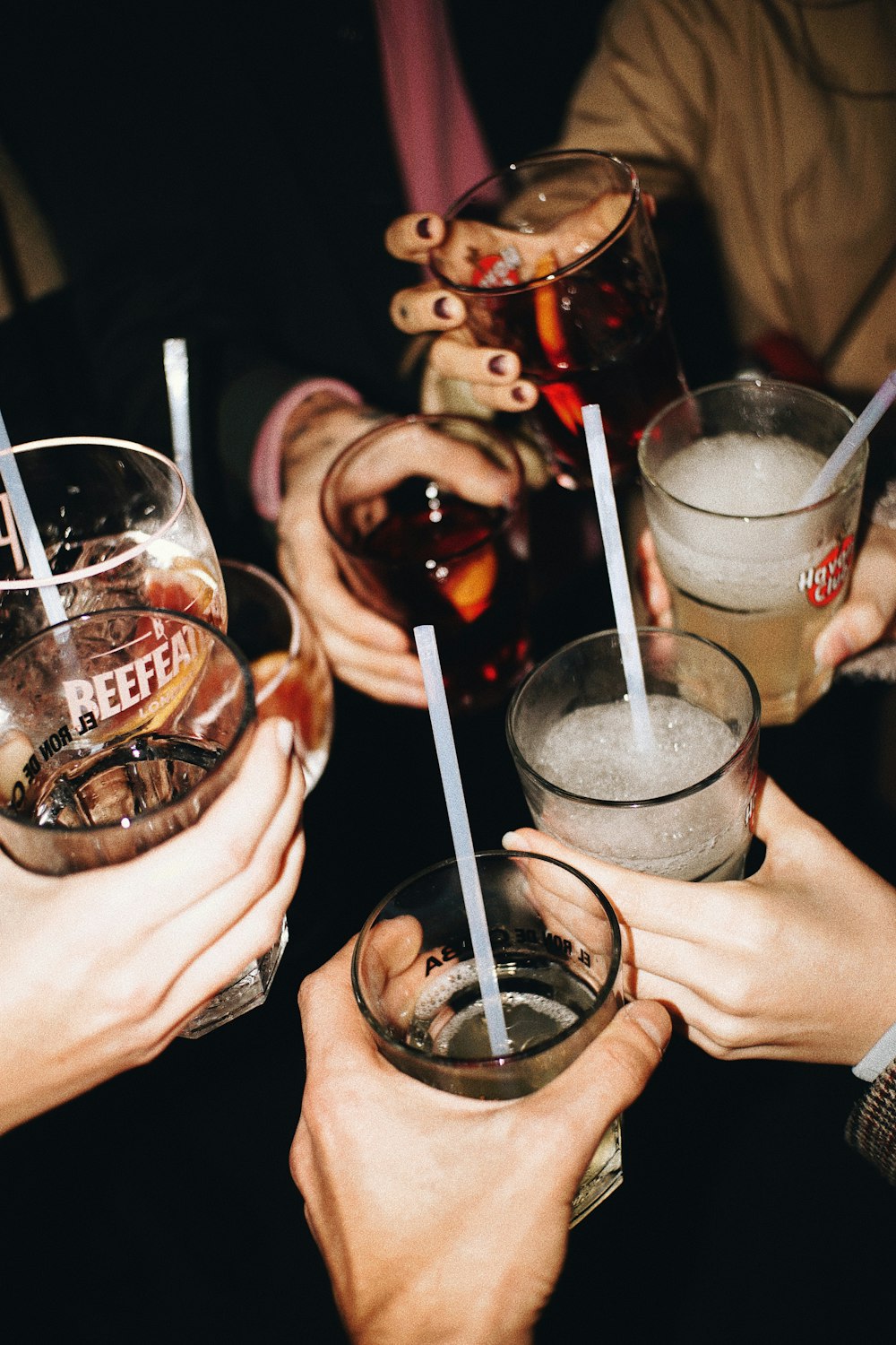 a group of people holding glasses with drinks in them