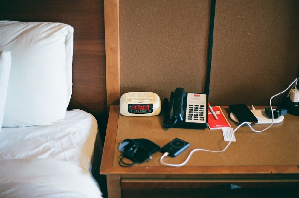 a hotel room with a bed, telephone, and a night stand